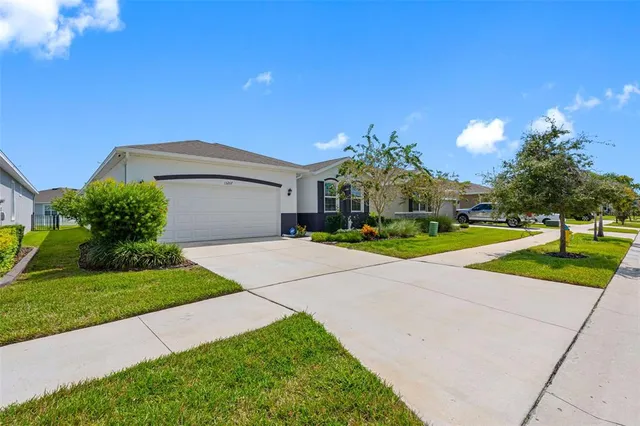 a front view of a house with a yard and garage