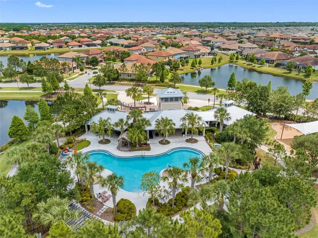 an aerial view of residential houses with outdoor space and river
