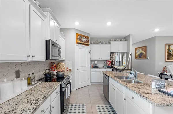 a kitchen with a sink stove and cabinets