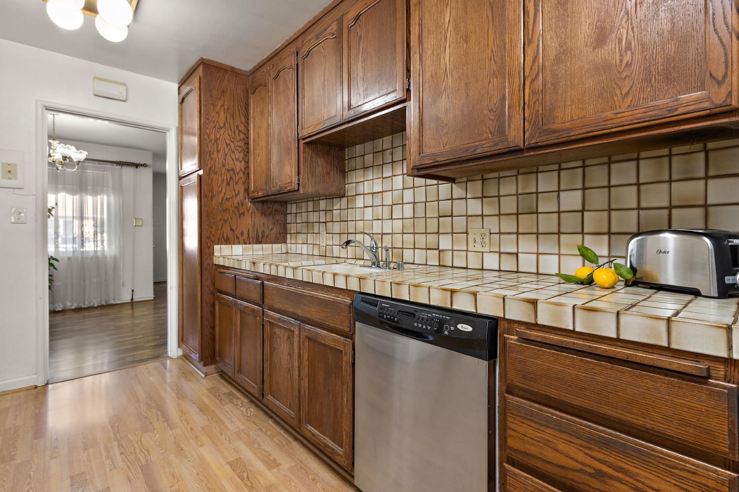928 Jean Way Hayward, CA 94545 - Photo 12 of 36 a kitchen with granite countertop wooden cabinets a sink and dishwasher
