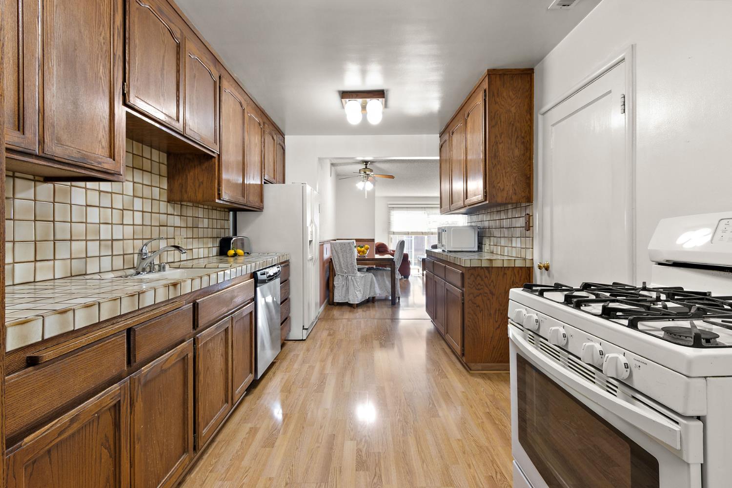 928 Jean Way Hayward, CA 94545 - Photo 13 of 36 a large kitchen with stainless steel appliances granite countertop a stove a sink dishwasher and a refrigerator