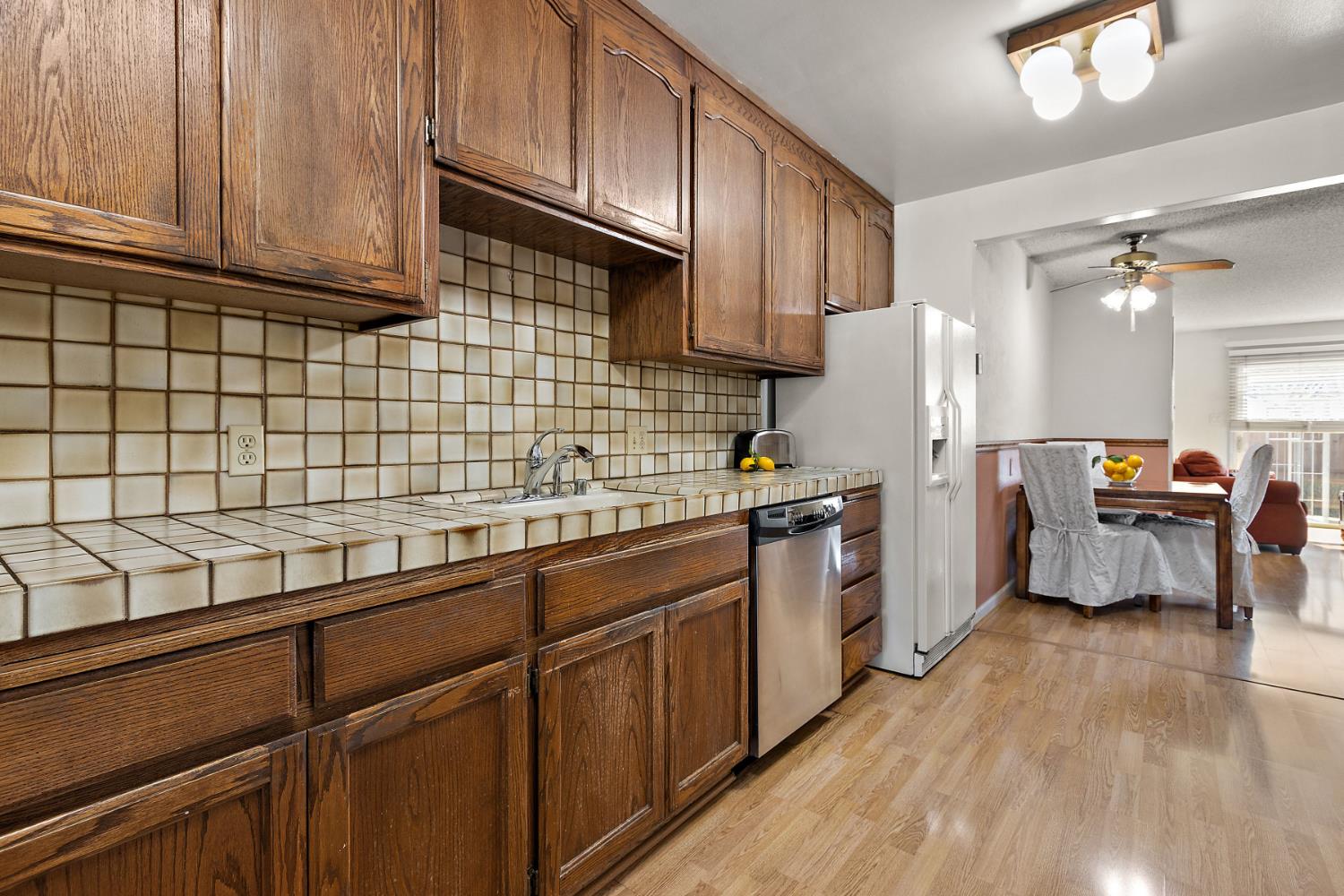 928 Jean Way Hayward, CA 94545 - Photo 14 of 36 a kitchen with refrigerator cabinets and wooden floor