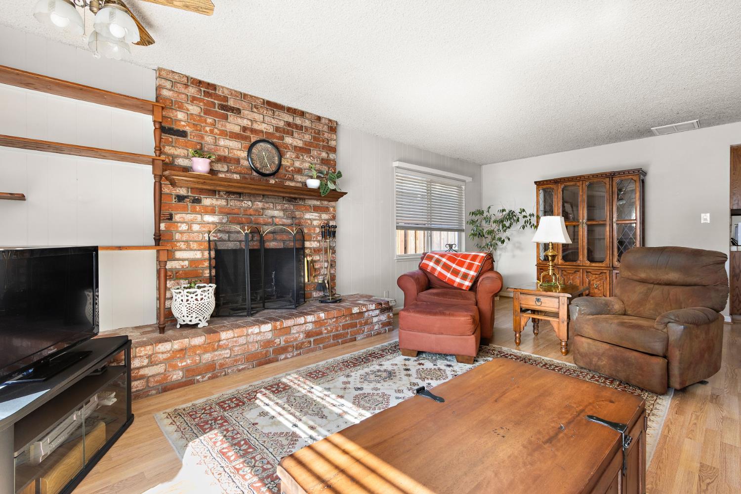 928 Jean Way Hayward, CA 94545 - Photo 19 of 36 a living room with furniture a flat screen tv and a fireplace