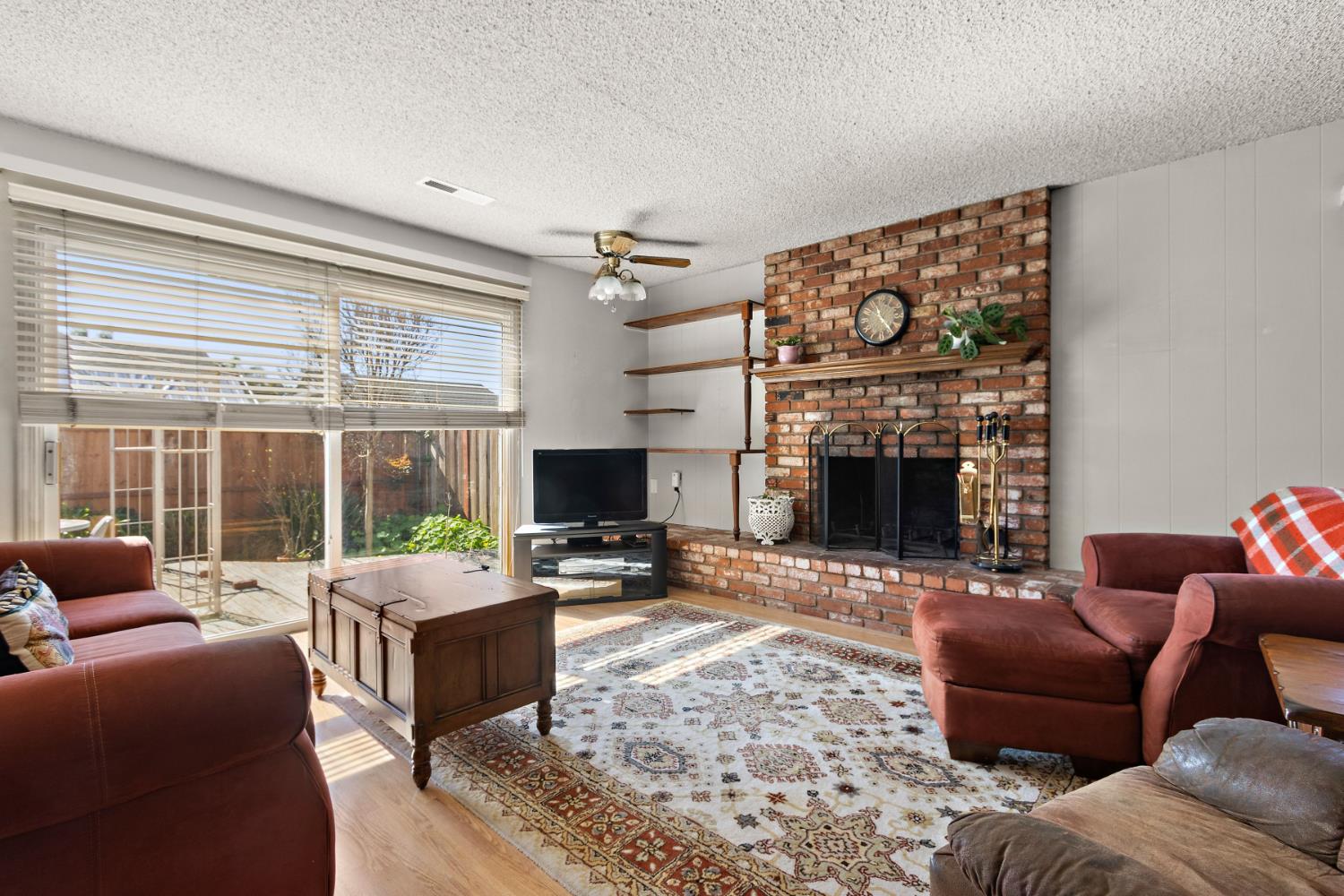 928 Jean Way Hayward, CA 94545 - Photo 20 of 36 a living room with furniture a fireplace and a flat screen tv