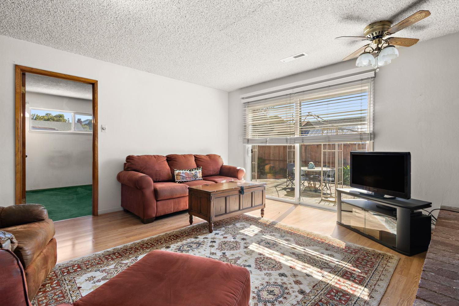 928 Jean Way Hayward, CA 94545 - Photo 32 of 36 a living room with furniture a flat screen tv and a fireplace