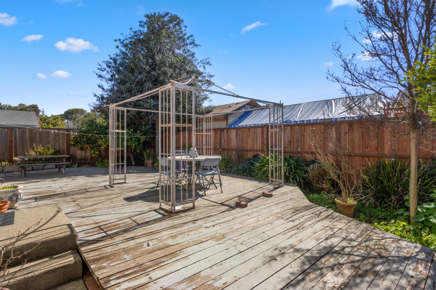 928 Jean Way Hayward, CA 94545 - Photo 34 of 36 a view of backyard with table and chairs potted plants and wooden fence