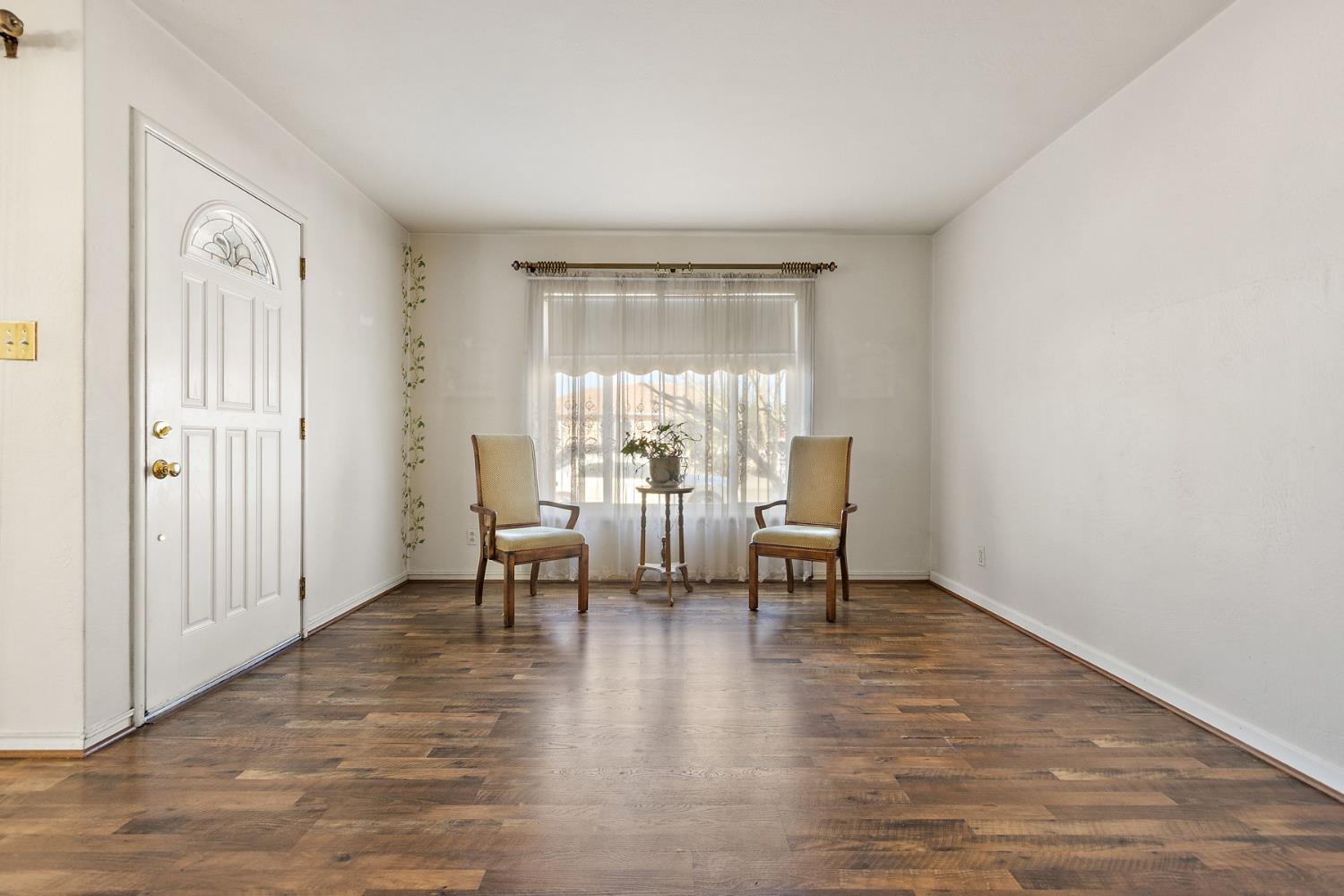 928 Jean Way Hayward, CA 94545 - Photo 6 of 36 a living room with couches and a dining table with wooden floor