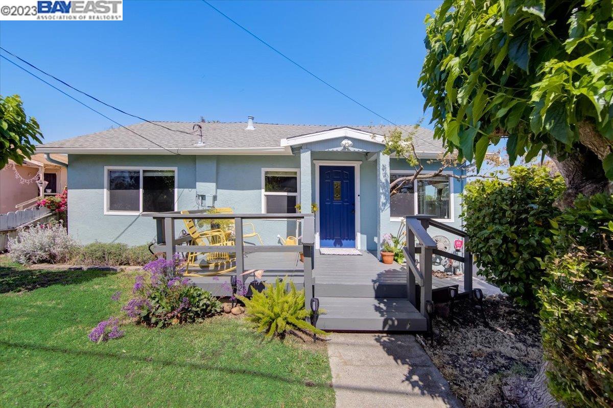 a front view of house with yard and outdoor seating