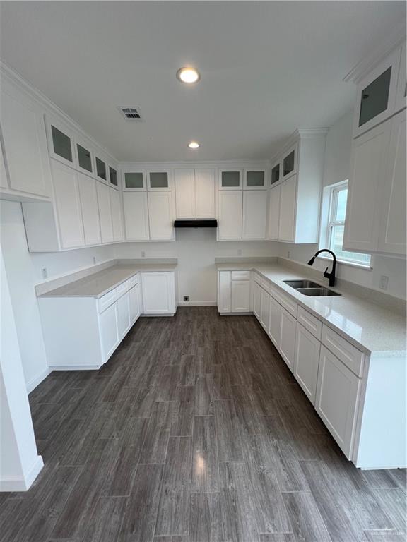 1624 West B Street Mission, TX 78572 - Photo 3 of 10 a kitchen with a sink and wooden floor