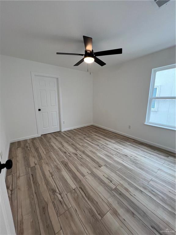 1624 West B Street Mission, TX 78572 - Photo 6 of 10 wooden floor in an empty room