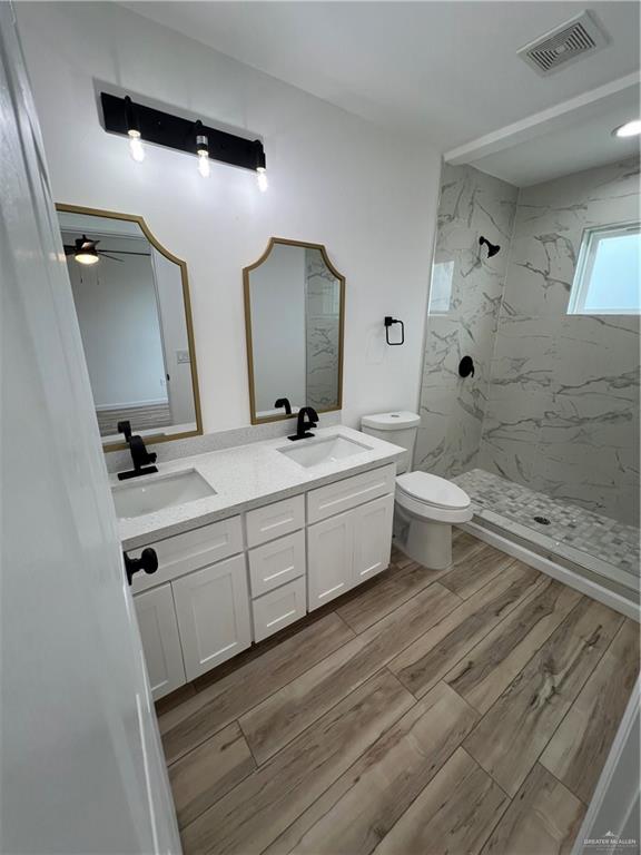 1624 West B Street Mission, TX 78572 - Photo 7 of 10 a bathroom with a double vanity sink mirror and toilet