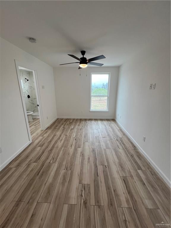 1624 West B Street Mission, TX 78572 - Photo 8 of 10 wooden floor in an empty room with a window