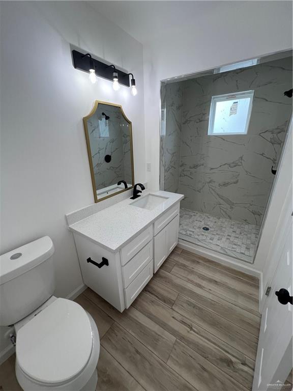 1624 West B Street Mission, TX 78572 - Photo 9 of 10 a white toilet sitting next to a bathroom sink