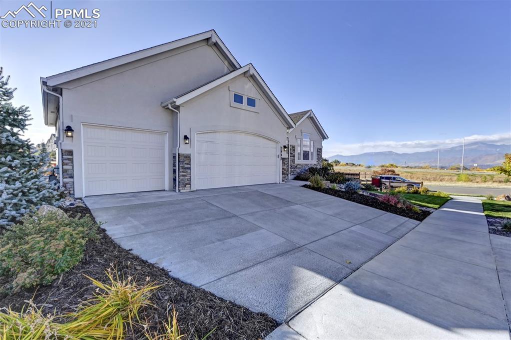 2903 Golden Meadow Way Colorado Springs, CO 80908 - Photo 2 of 49 a view of a house with a yard