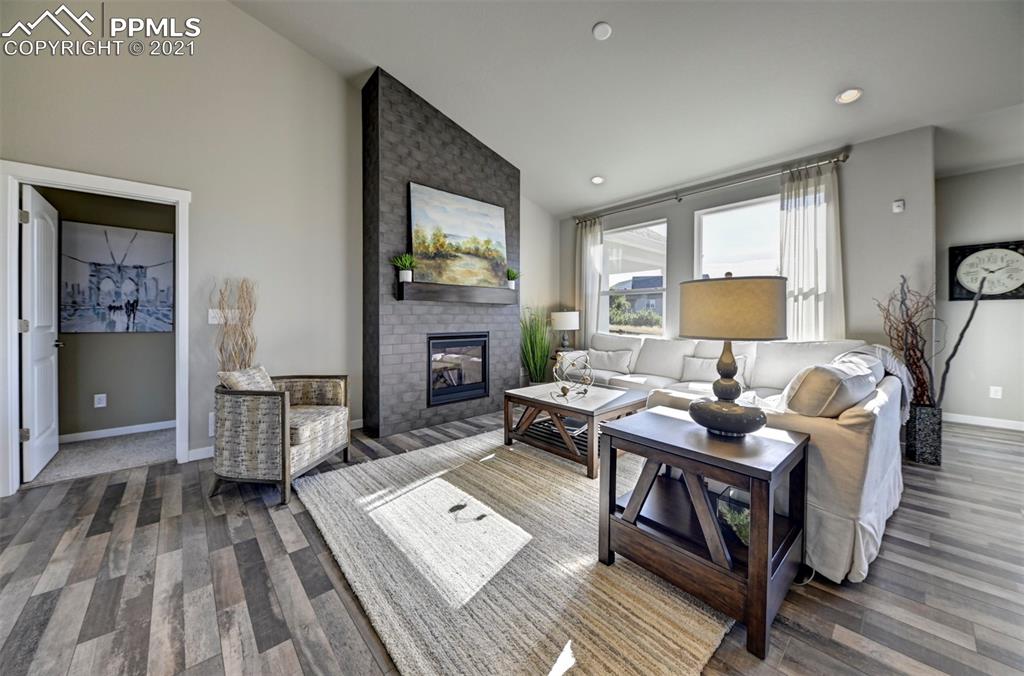 2903 Golden Meadow Way Colorado Springs, CO 80908 - Photo 11 of 49 a living room with furniture and a fireplace