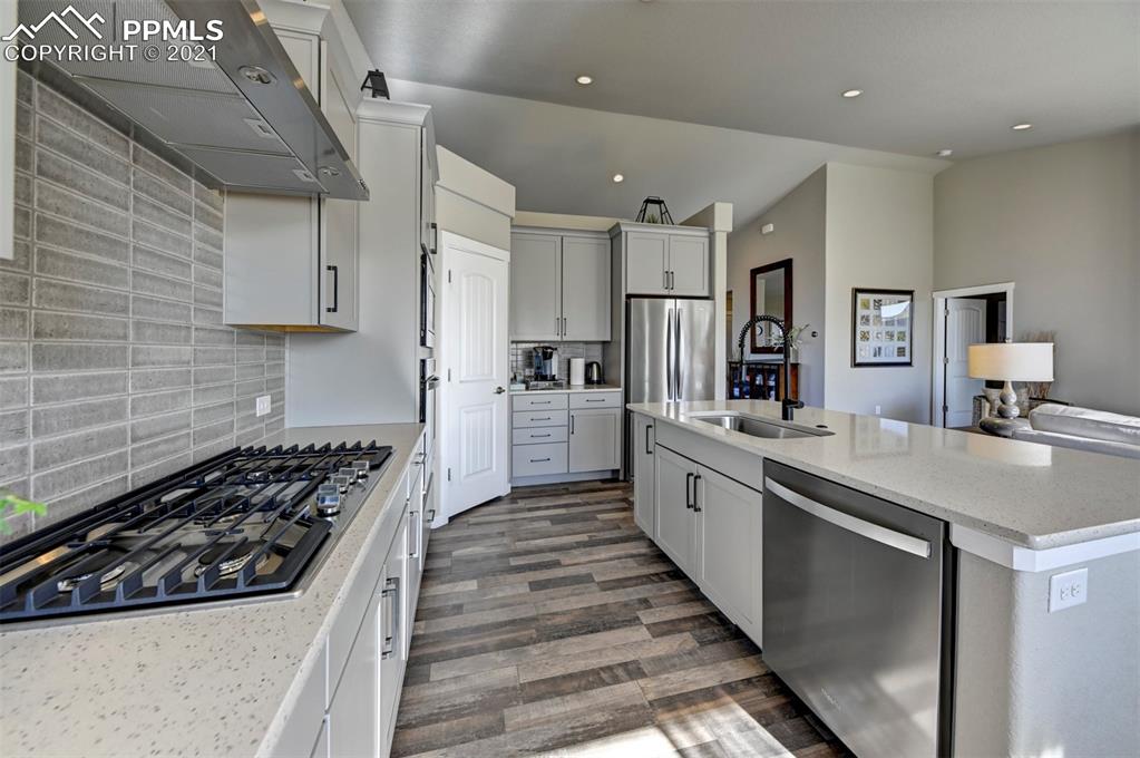 2903 Golden Meadow Way Colorado Springs, CO 80908 - Photo 15 of 49 a large kitchen with stainless steel appliances granite countertop a stove and a sink
