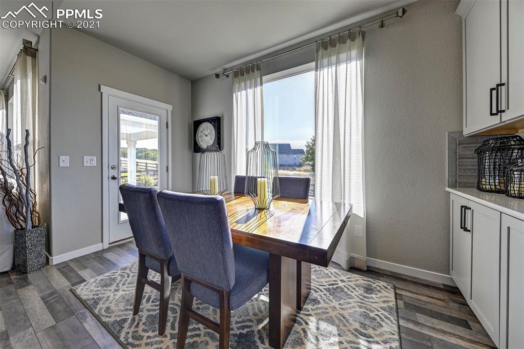 2903 Golden Meadow Way Colorado Springs, CO 80908 - Photo 16 of 49 a view of a dining room with furniture window and wooden floor