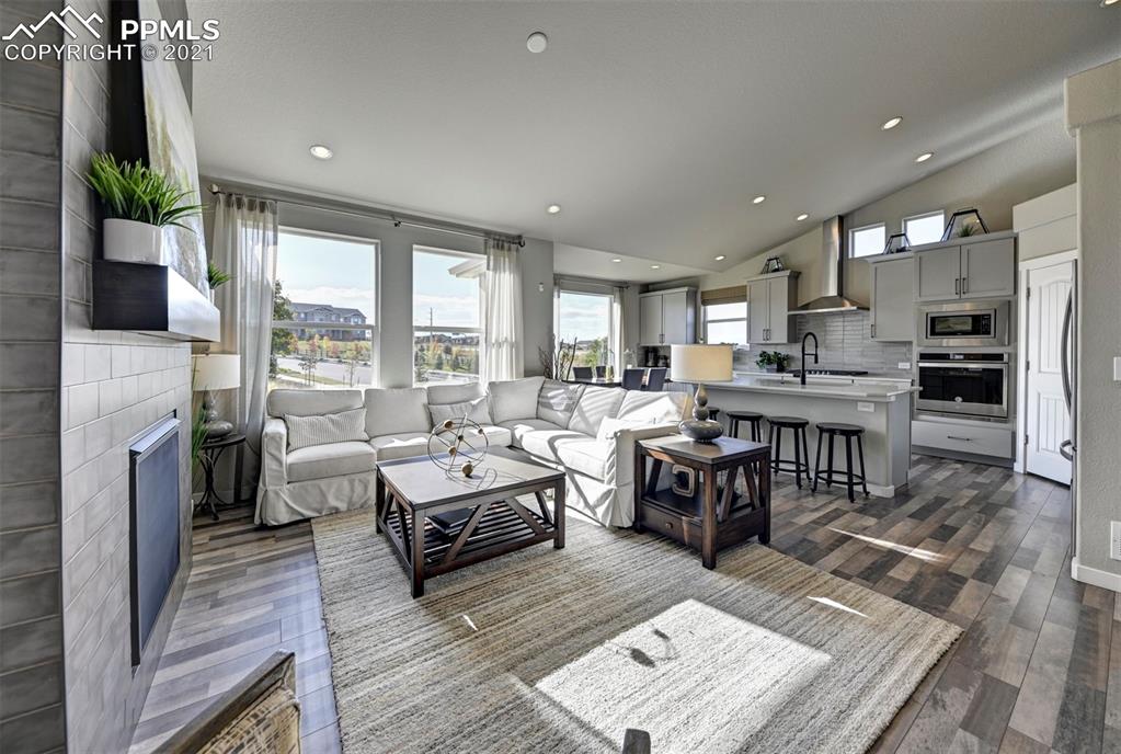 2903 Golden Meadow Way Colorado Springs, CO 80908 - Photo 17 of 49 a living room with lots of furniture and a fireplace
