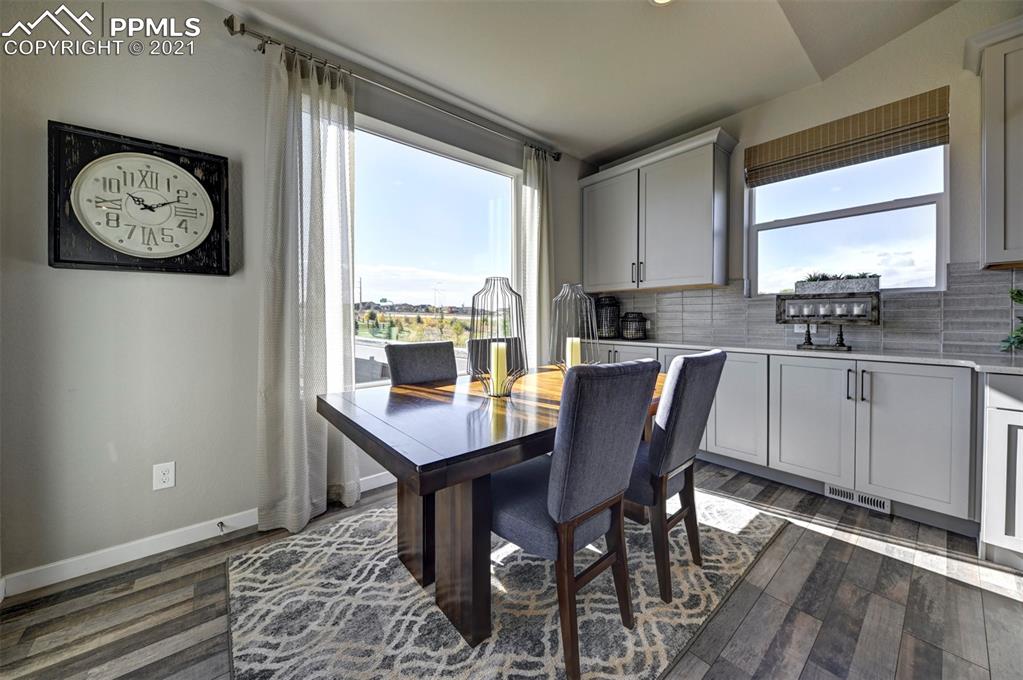 2903 Golden Meadow Way Colorado Springs, CO 80908 - Photo 18 of 49 a view of a dining room with furniture window and wooden floor