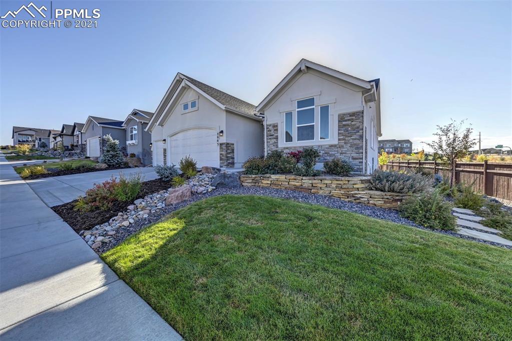 2903 Golden Meadow Way Colorado Springs, CO 80908 - Photo 3 of 49 a front view of a house with a yard and garage