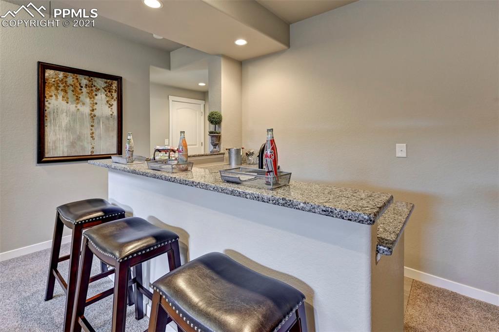 2903 Golden Meadow Way Colorado Springs, CO 80908 - Photo 26 of 49 a kitchen with stainless steel appliances granite countertop a sink and a refrigerator