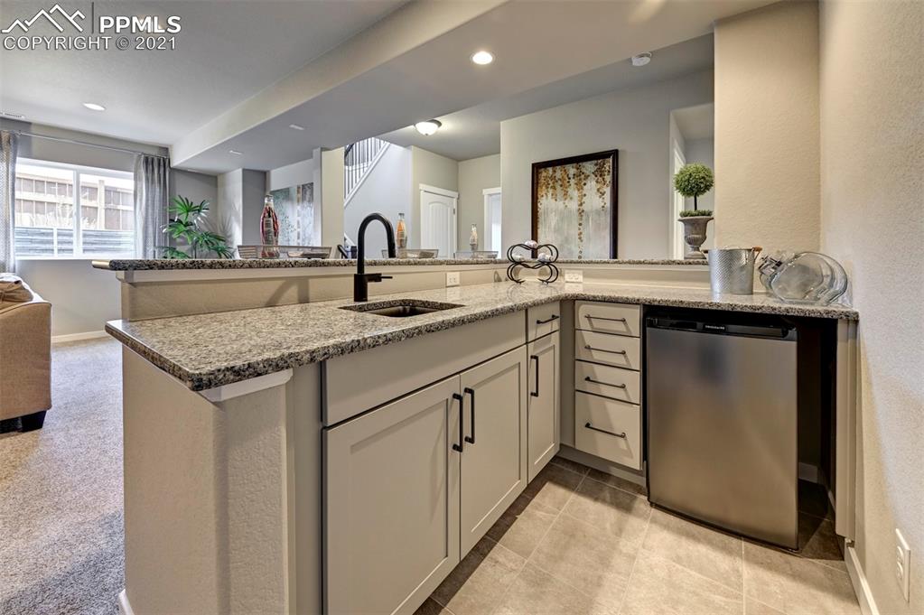 2903 Golden Meadow Way Colorado Springs, CO 80908 - Photo 27 of 49 a kitchen with sink and mirror
