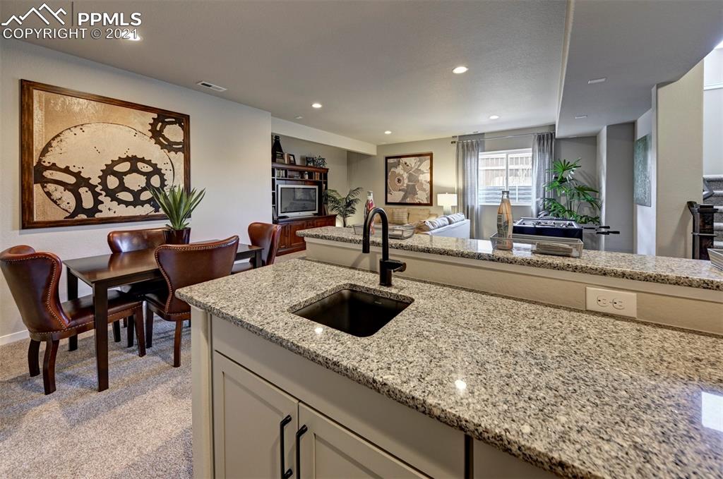 2903 Golden Meadow Way Colorado Springs, CO 80908 - Photo 28 of 49 a kitchen with a sink and large window