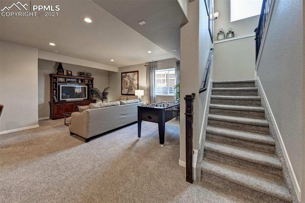 2903 Golden Meadow Way Colorado Springs, CO 80908 - Photo 29 of 49 a living room with furniture and a flat screen tv