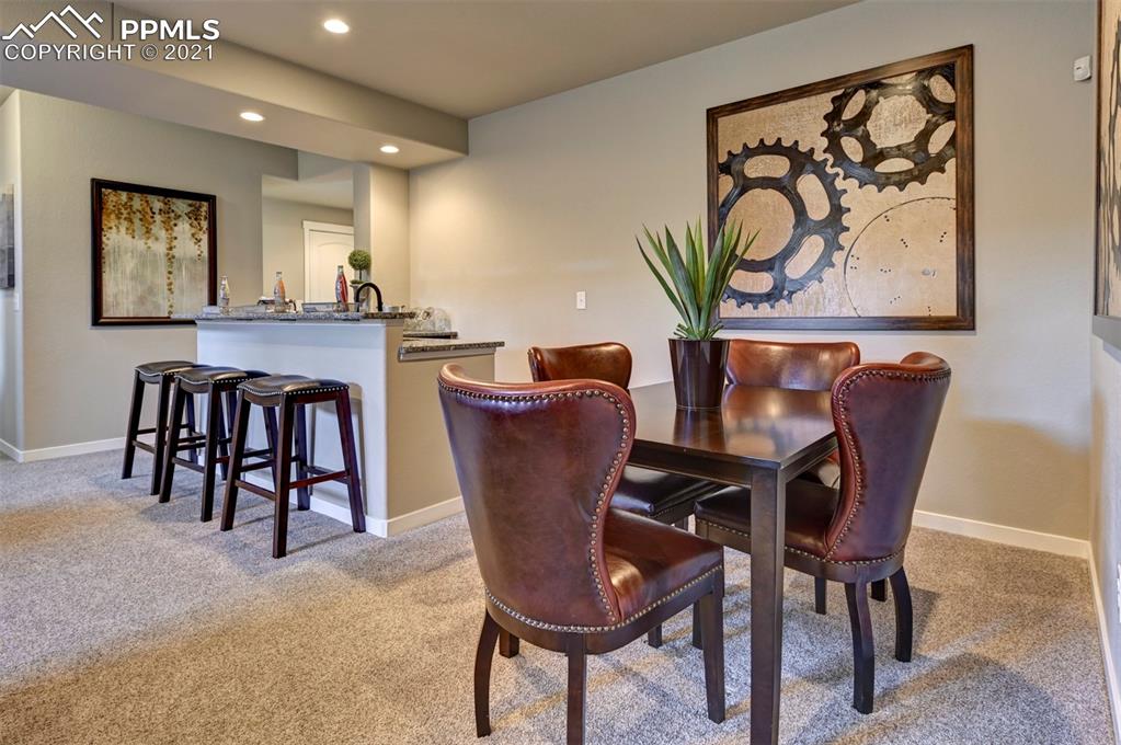 2903 Golden Meadow Way Colorado Springs, CO 80908 - Photo 30 of 49 a view of a dining room with furniture and a potted plant