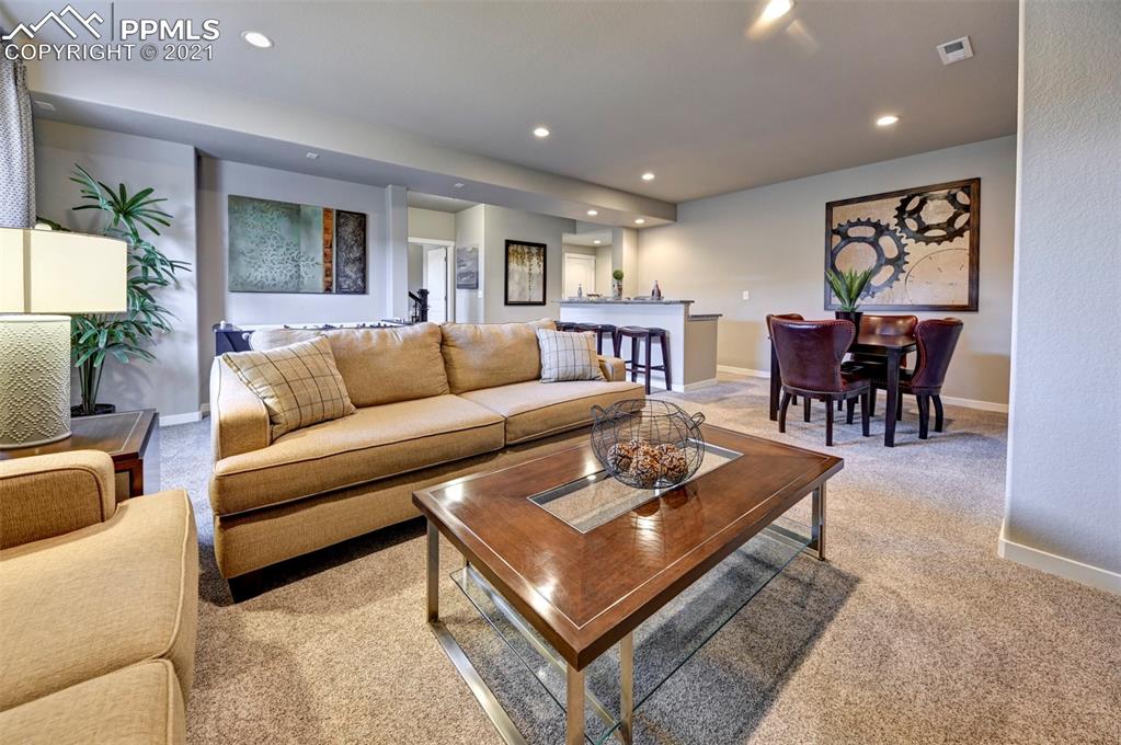 2903 Golden Meadow Way Colorado Springs, CO 80908 - Photo 31 of 49 a living room with furniture potted plant and a table