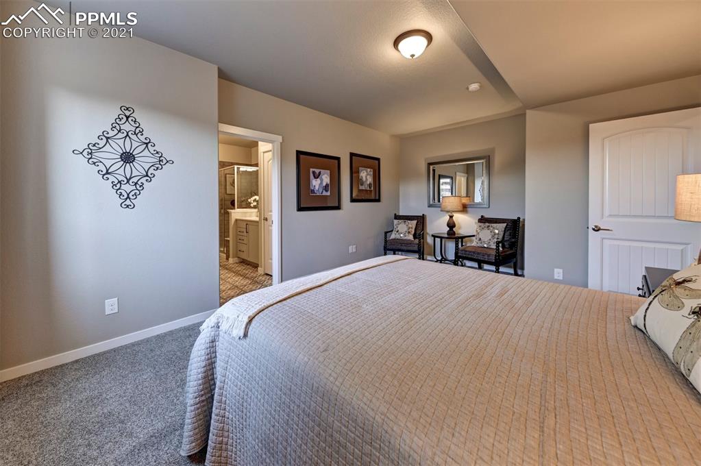 2903 Golden Meadow Way Colorado Springs, CO 80908 - Photo 35 of 49 a bed room with a bed and a chair