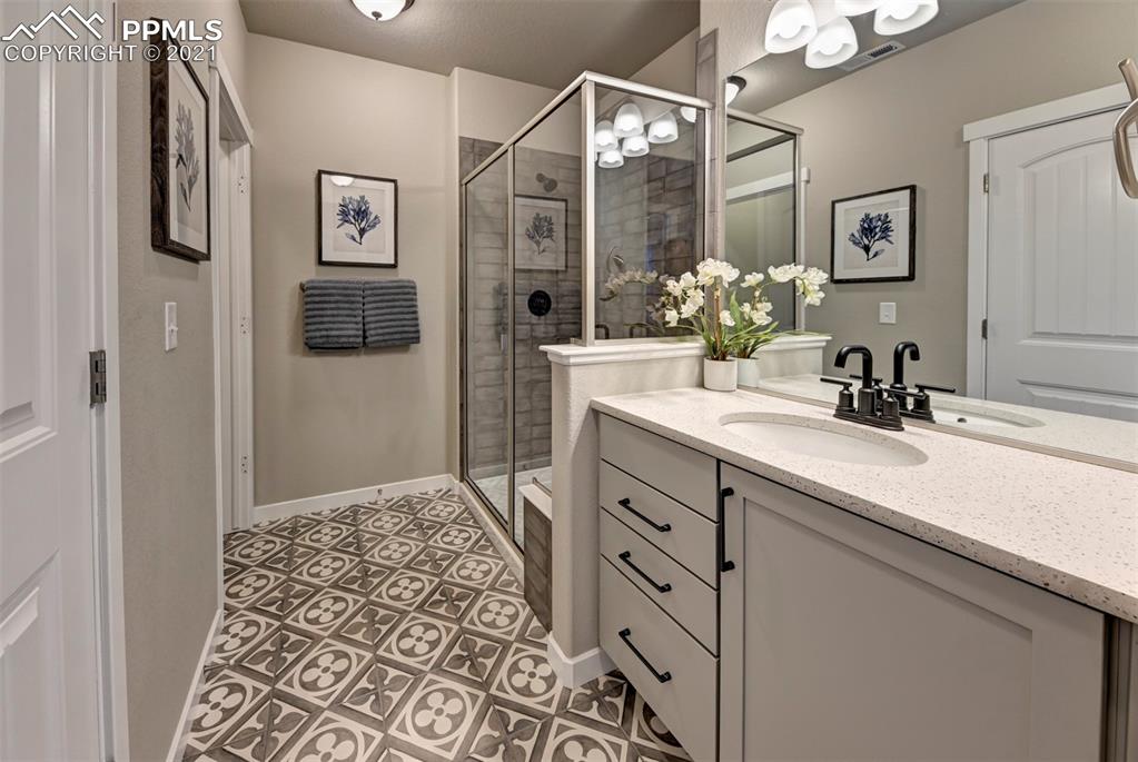 2903 Golden Meadow Way Colorado Springs, CO 80908 - Photo 36 of 49 a bathroom with a sink vanity and a mirror