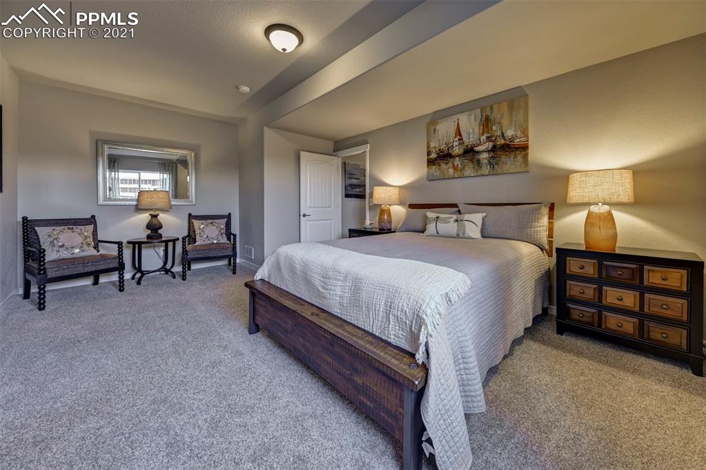 2903 Golden Meadow Way Colorado Springs, CO 80908 - Photo 37 of 49 a bedroom with a bed and a night stand