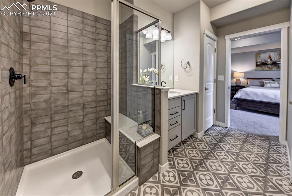 2903 Golden Meadow Way Colorado Springs, CO 80908 - Photo 38 of 49 a bathroom with a tub sink and mirror