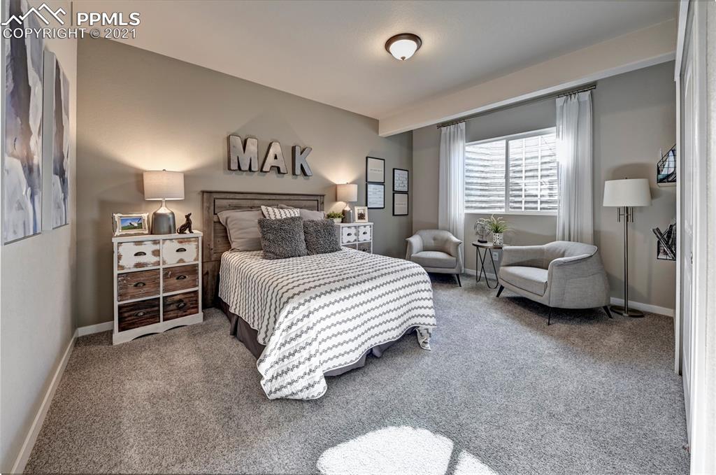 2903 Golden Meadow Way Colorado Springs, CO 80908 - Photo 42 of 49 a bedroom with bed and a large window