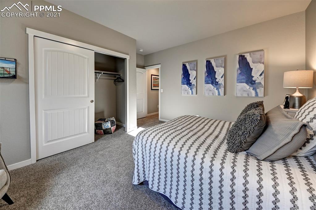 2903 Golden Meadow Way Colorado Springs, CO 80908 - Photo 43 of 49 a bedroom with a bed and a walk in closet