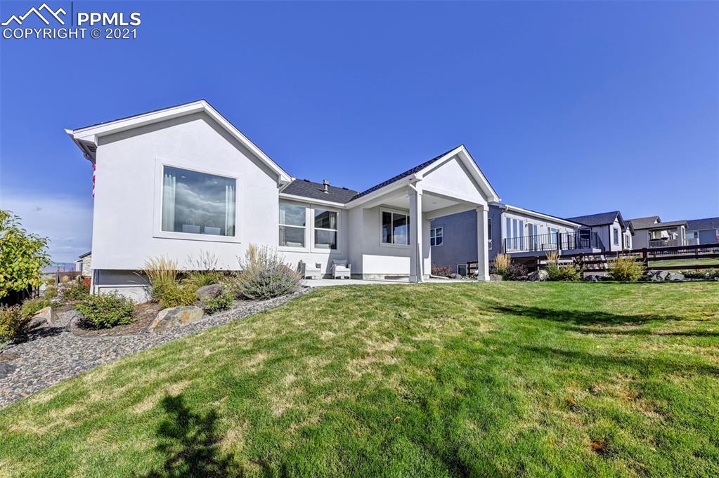 2903 Golden Meadow Way Colorado Springs, CO 80908 - Photo 46 of 49 a front view of a house with a garden