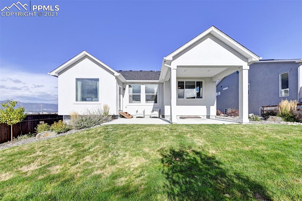 2903 Golden Meadow Way Colorado Springs, CO 80908 - Photo 47 of 49 a front view of a house with a yard