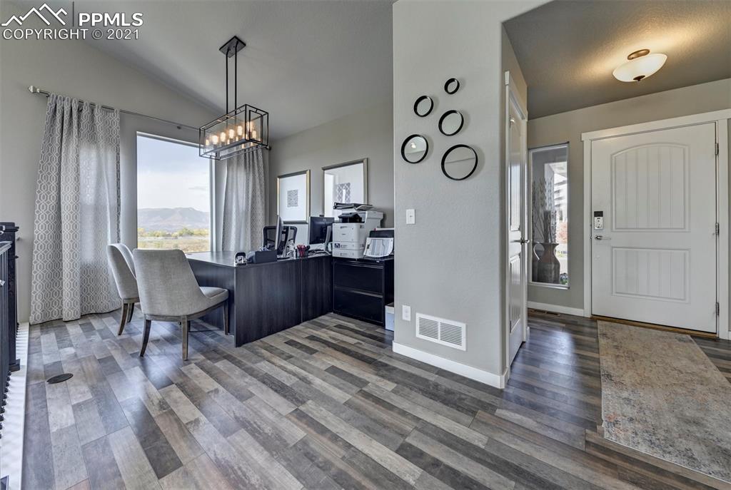 2903 Golden Meadow Way Colorado Springs, CO 80908 - Photo 6 of 49 a view of a dining room with furniture window and wooden floor