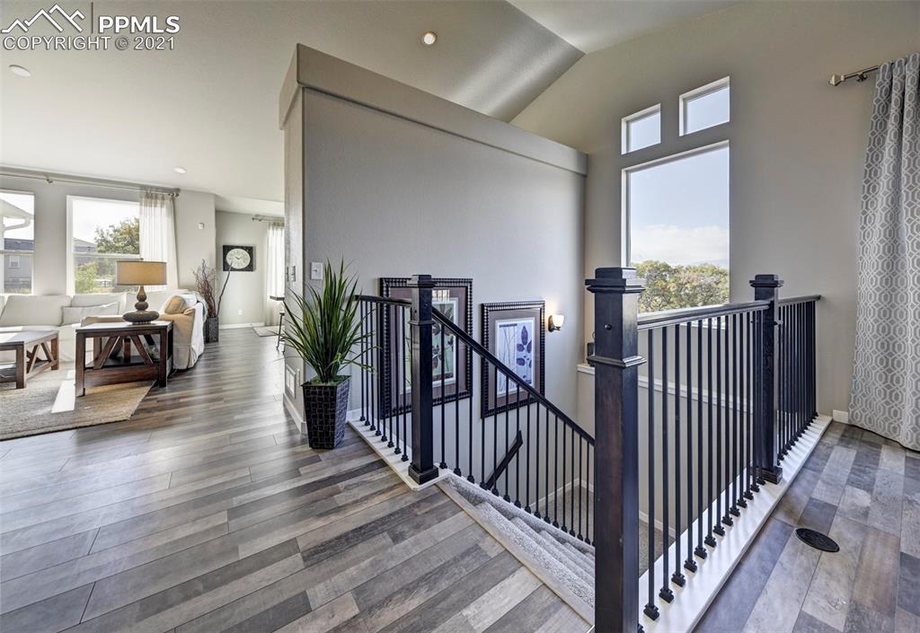 2903 Golden Meadow Way Colorado Springs, CO 80908 - Photo 9 of 49 a view of a hallway with wooden floor and stairs