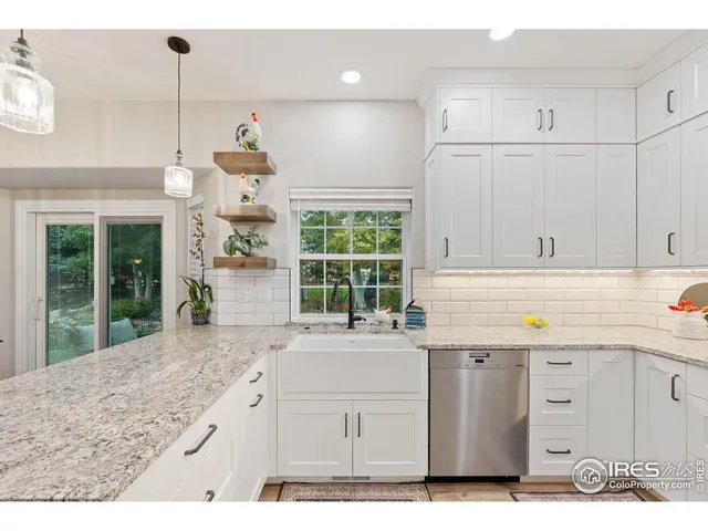 a kitchen with a sink window and cabinets