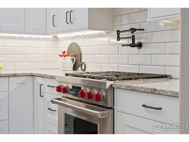 a kitchen with granite countertop a sink and cabinets