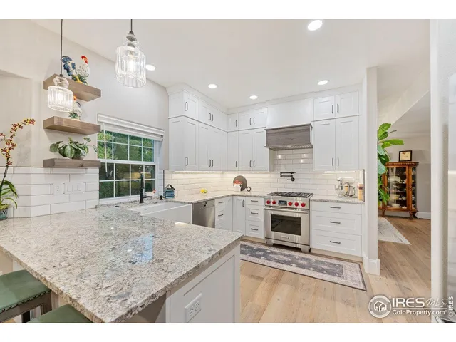 a kitchen with a stove a refrigerator and a sink