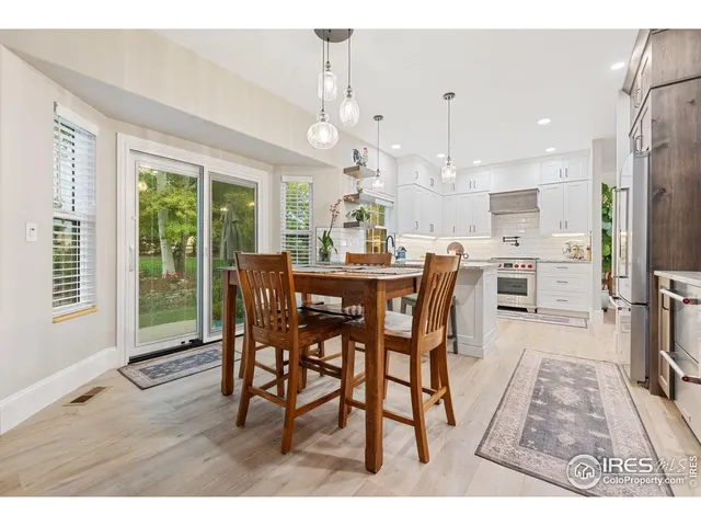 a dining room with furniture a chandelier and wooden floor