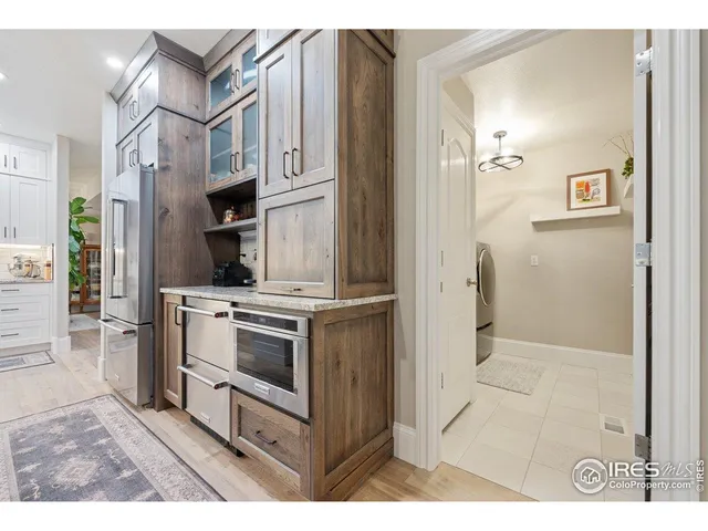 a kitchen with stainless steel appliances a stove a refrigerator and cabinets