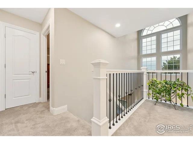 a view of a hallway to a livingroom with furniture
