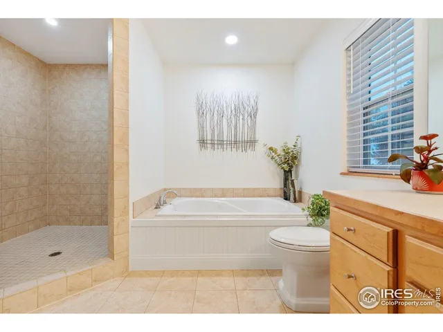 a bathroom with a bathtub shower sink mirror and toilet