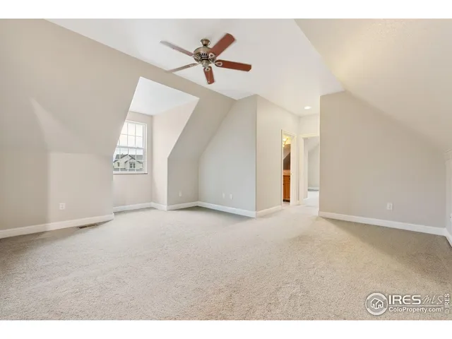 a view of a livingroom with a ceiling fan and window