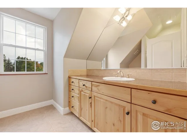 a bathroom with a sink a mirror and a window