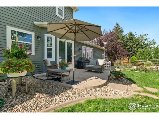 a backyard of a house with table and chairs